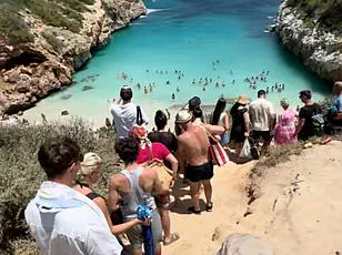 German Millionaires Battle Overcrowding and Social Media Frenzy at Mallorca's Troubled Beach